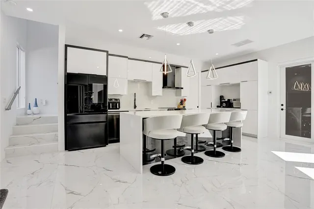 a kitchen with stainless steel appliances kitchen island granite countertop a sink and cabinets