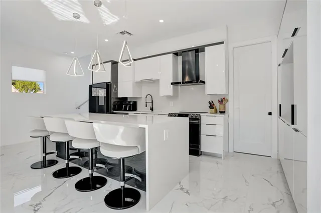 a kitchen with stainless steel appliances kitchen island granite countertop a sink and cabinets