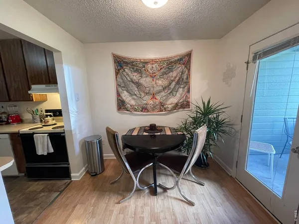a view of a workspace with furniture and wooden floor