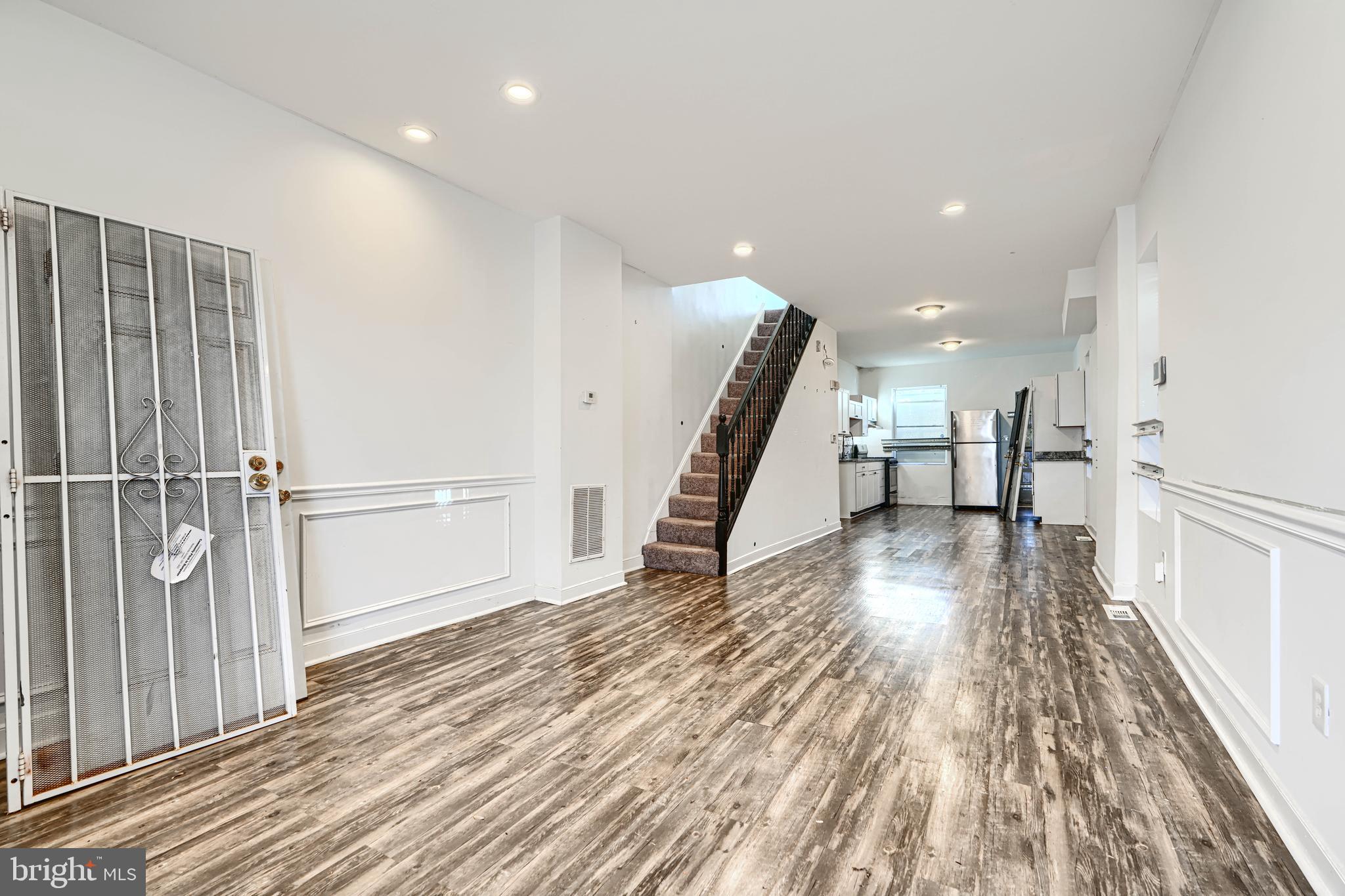 1601 East 28th Street Baltimore, MD 21218 - Photo 12 of 34 a view of a hallway with wooden floor and staircase