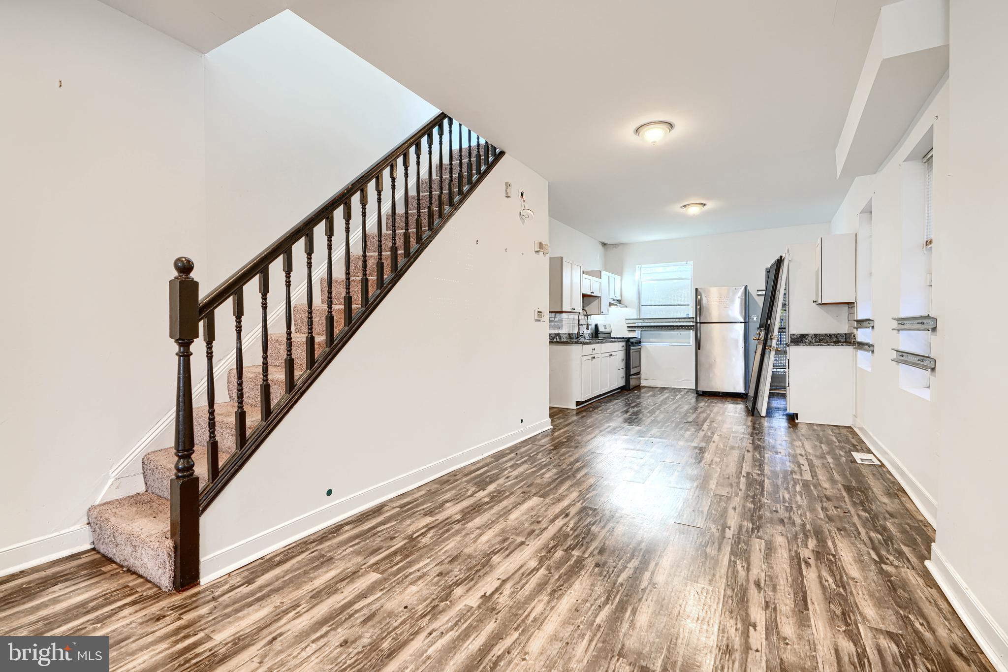 1601 East 28th Street Baltimore, MD 21218 - Photo 13 of 34 a view of a kitchen with wooden floor and electronic appliances