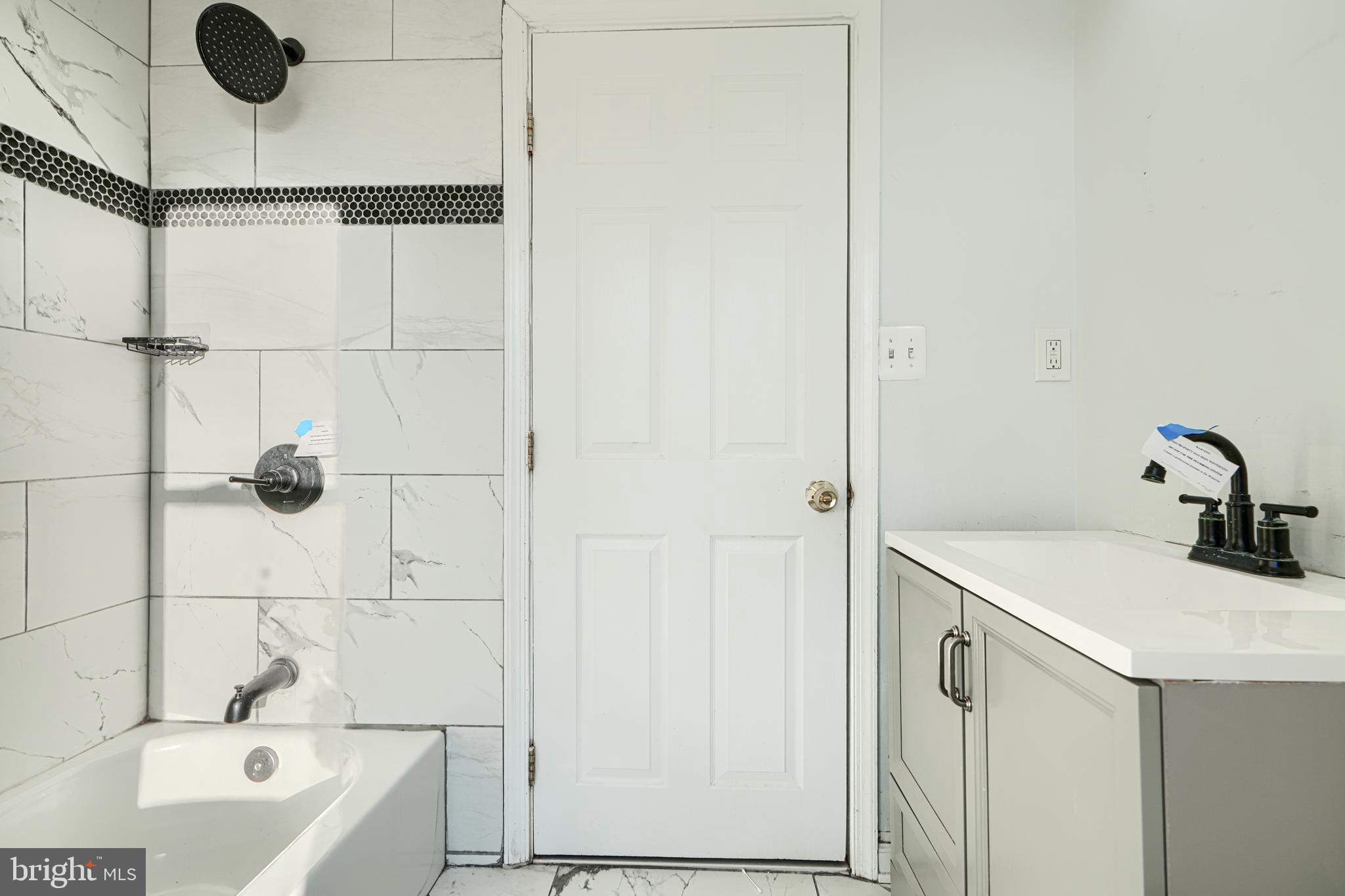 1601 East 28th Street Baltimore, MD 21218 - Photo 23 of 34 a bathroom with a sink and a bathtub