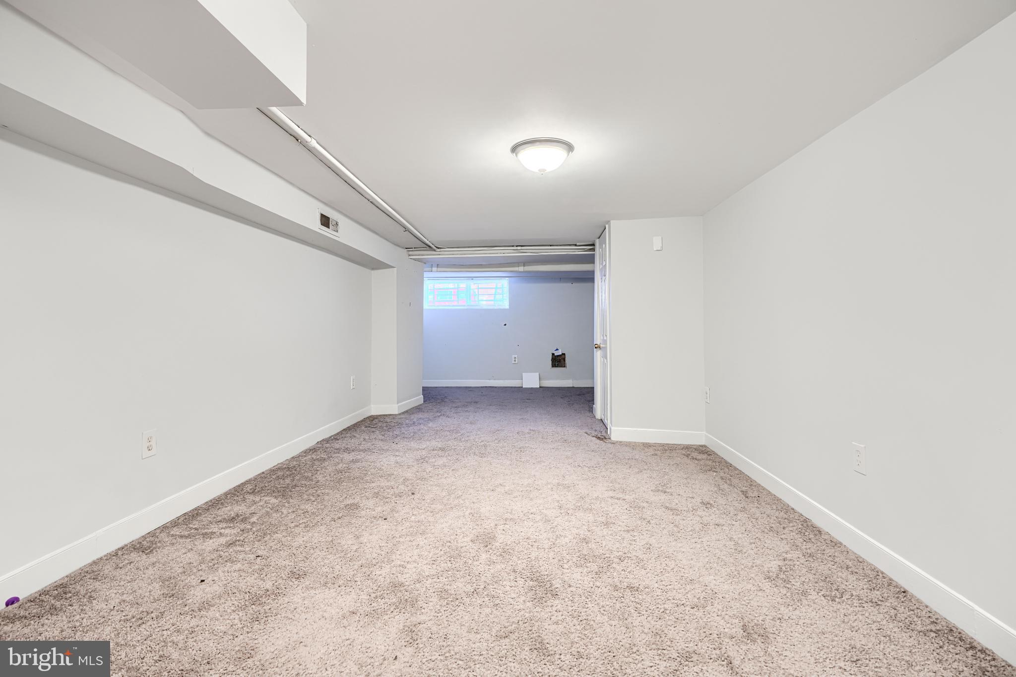 1601 East 28th Street Baltimore, MD 21218 - Photo 28 of 34 an empty room with a natural light