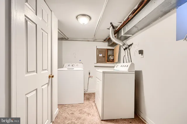 a utility room with a sink dryer and washer