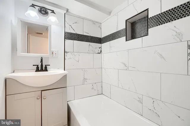 a bathroom with a sink and mirror
