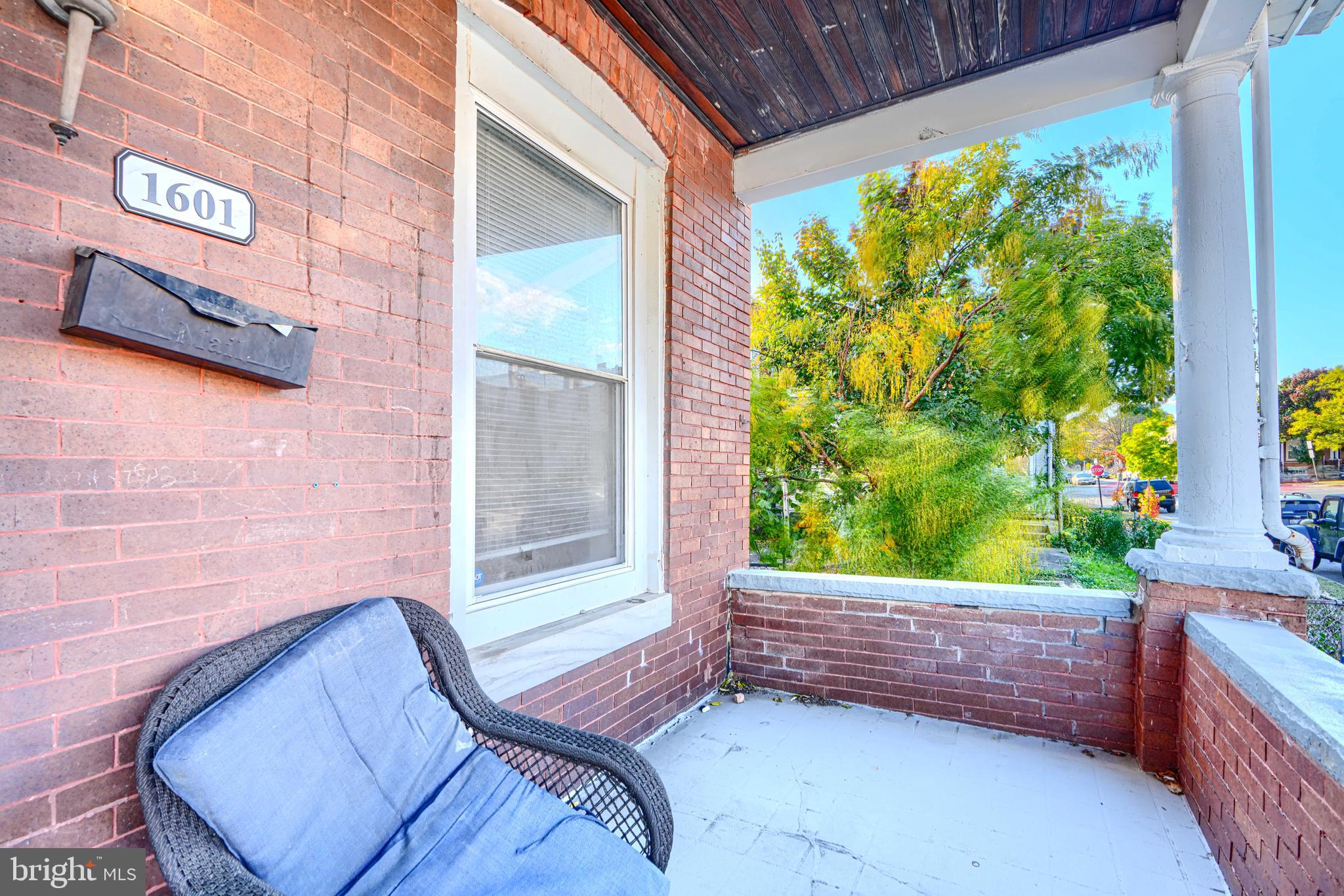 1601 East 28th Street Baltimore, MD 21218 - Photo 4 of 34 a view of a porch with a bench