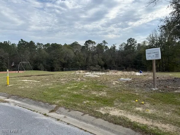 a swimming pool with trees in the background