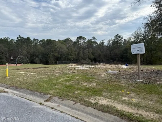 a swimming pool with trees in the background