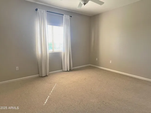 an empty room with a empty space and windows