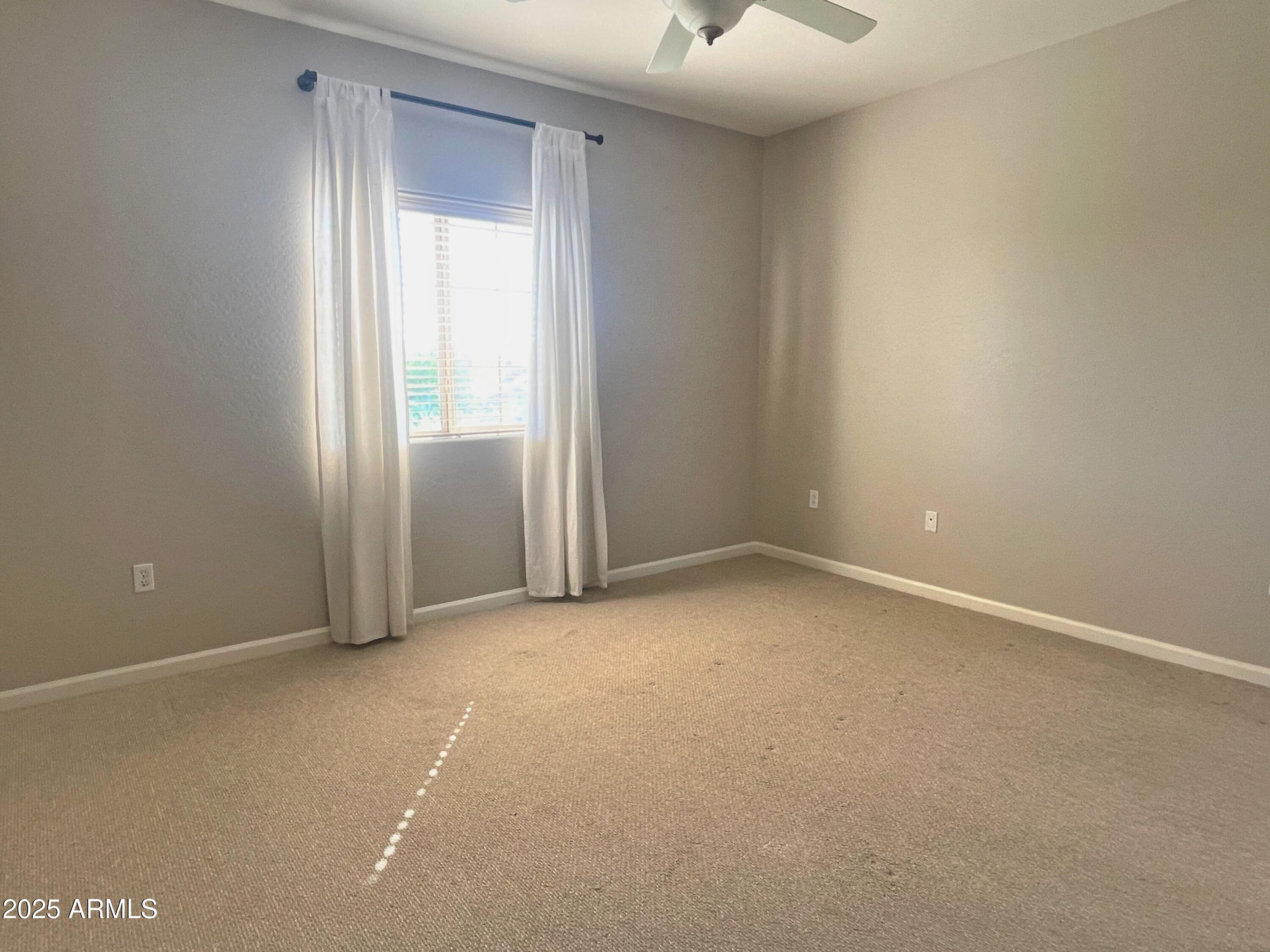 3935 East Rough Rider Road, Unit 1167 Phoenix, AZ 85050 - Photo 12 of 29 an empty room with a empty space and windows