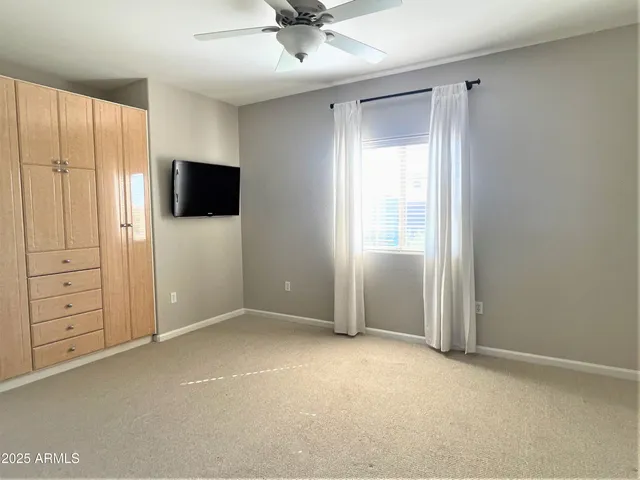 an empty room with closet and wooden floor