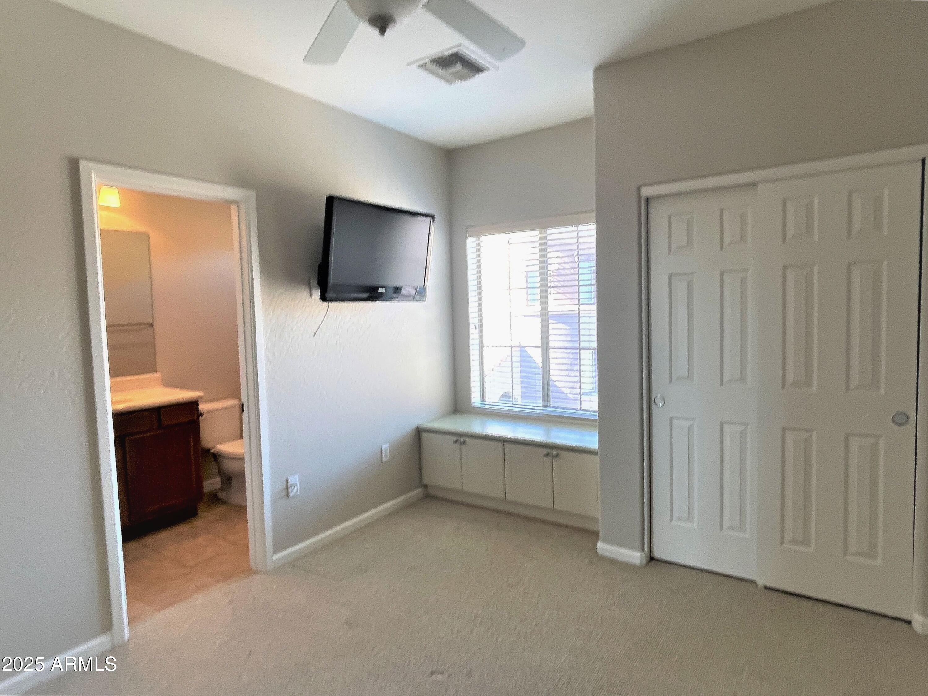 3935 East Rough Rider Road, Unit 1167 Phoenix, AZ 85050 - Photo 18 of 29 wooden floor and window in a room