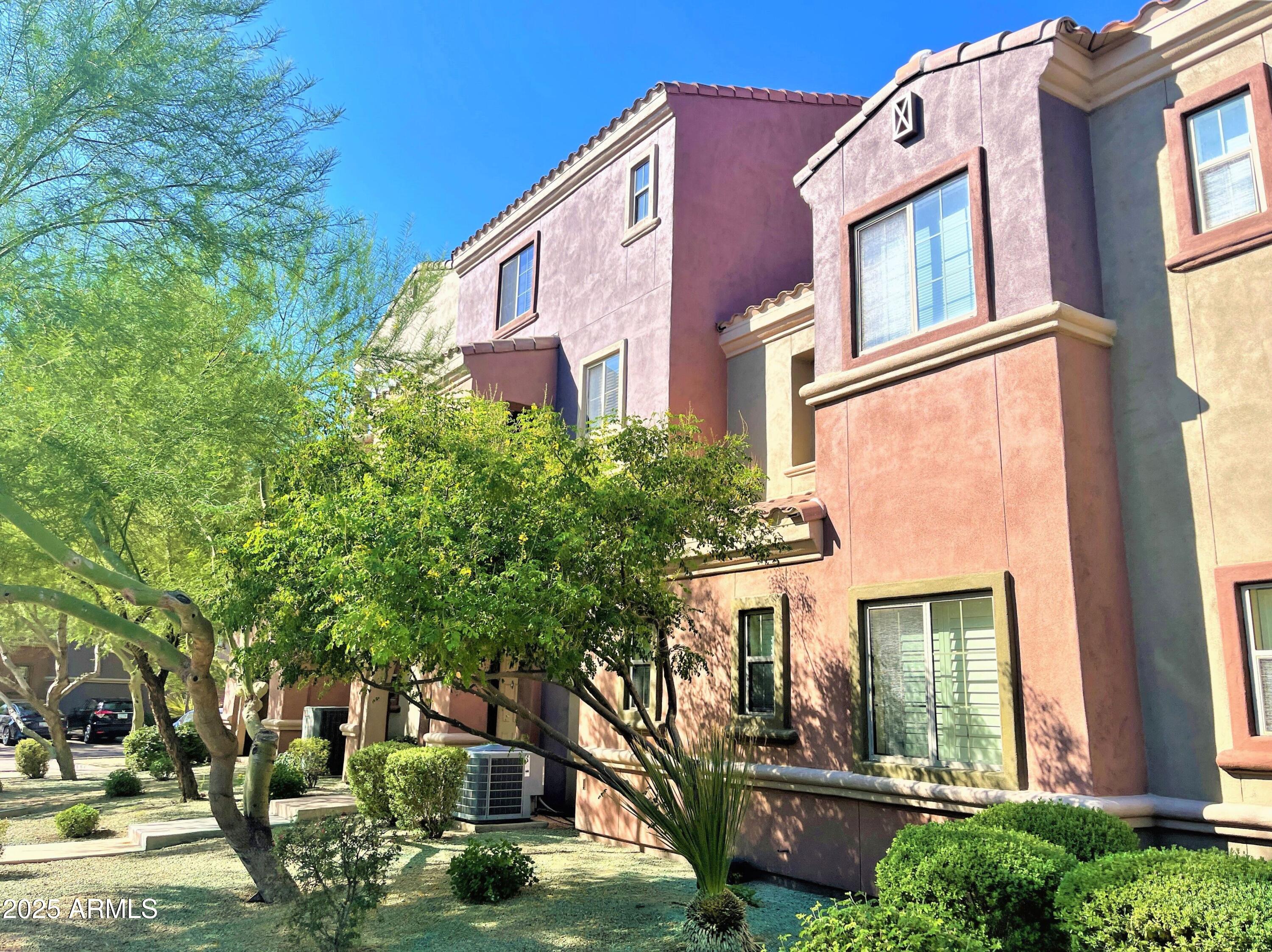 3935 East Rough Rider Road, Unit 1167 Phoenix, AZ 85050 - Photo 2 of 29 a view of a building with a yard
