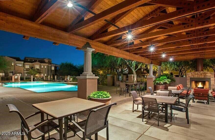 3935 East Rough Rider Road, Unit 1167 Phoenix, AZ 85050 - Photo 23 of 29 a view of a patio with a table and chairs under a umbrella