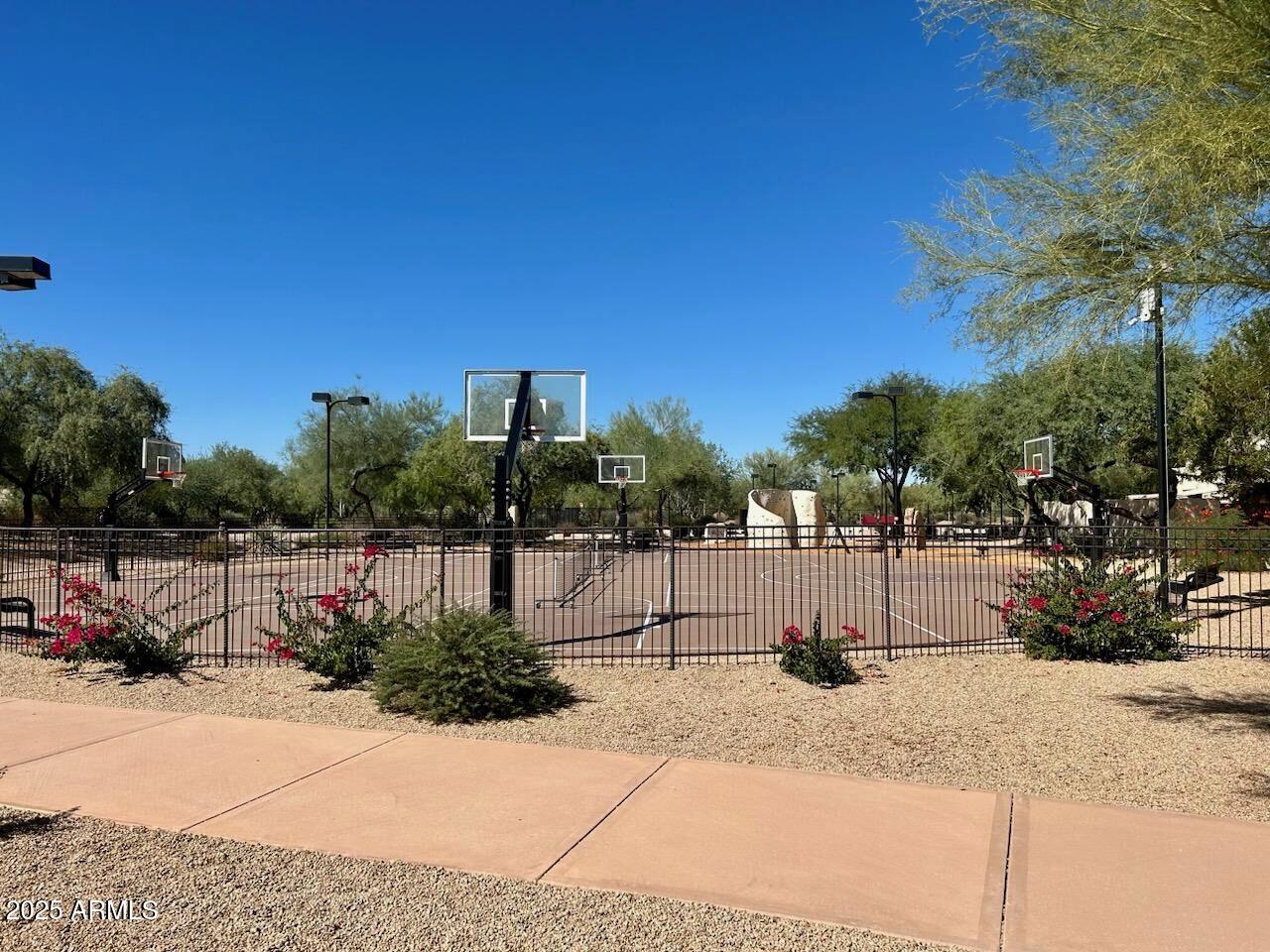 3935 East Rough Rider Road, Unit 1167 Phoenix, AZ 85050 - Photo 27 of 29 a view of a lake with a bench and roof