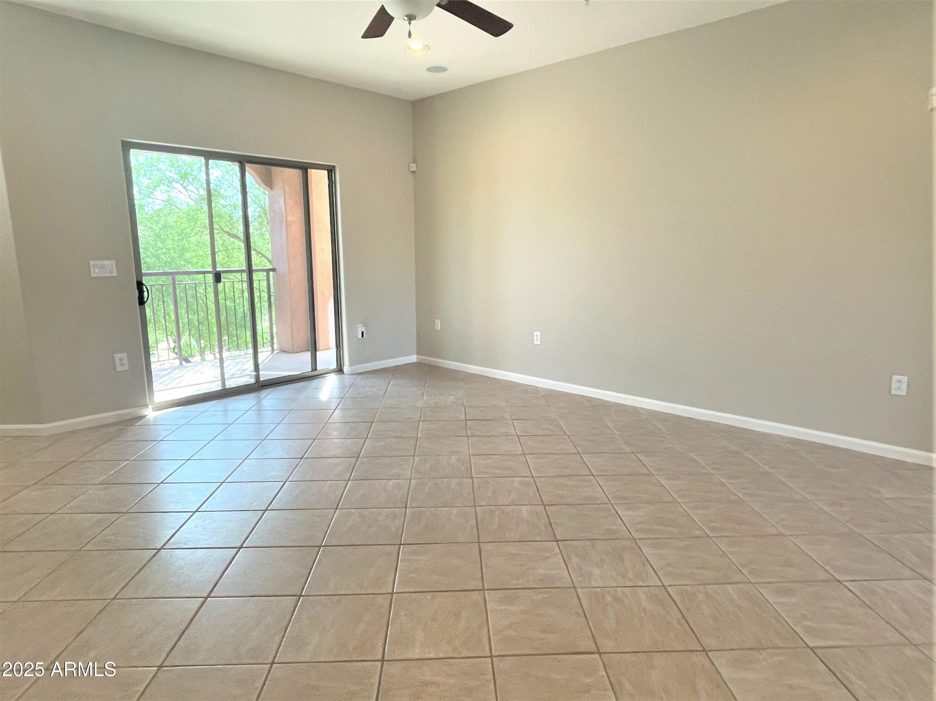 3935 East Rough Rider Road, Unit 1167 Phoenix, AZ 85050 - Photo 4 of 29 a view of an empty room with a window