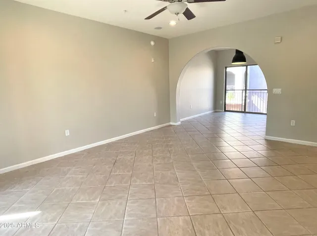 an empty room with a fireplace and windows