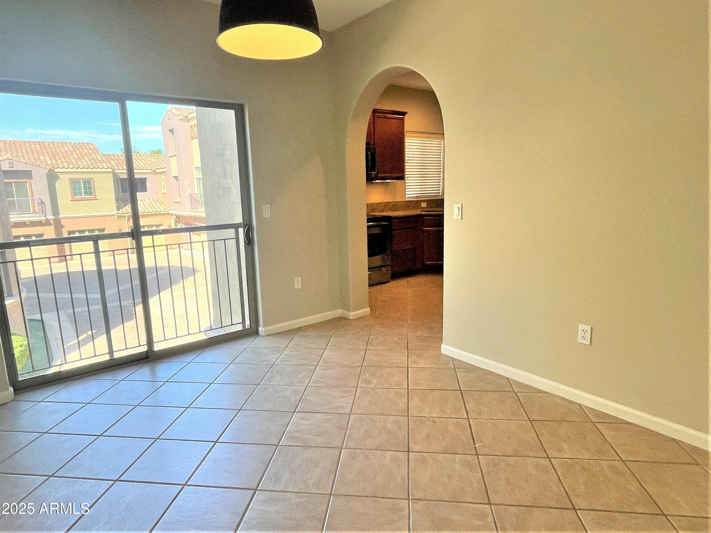 3935 East Rough Rider Road, Unit 1167 Phoenix, AZ 85050 - Photo 8 of 29 a view of an empty room and window