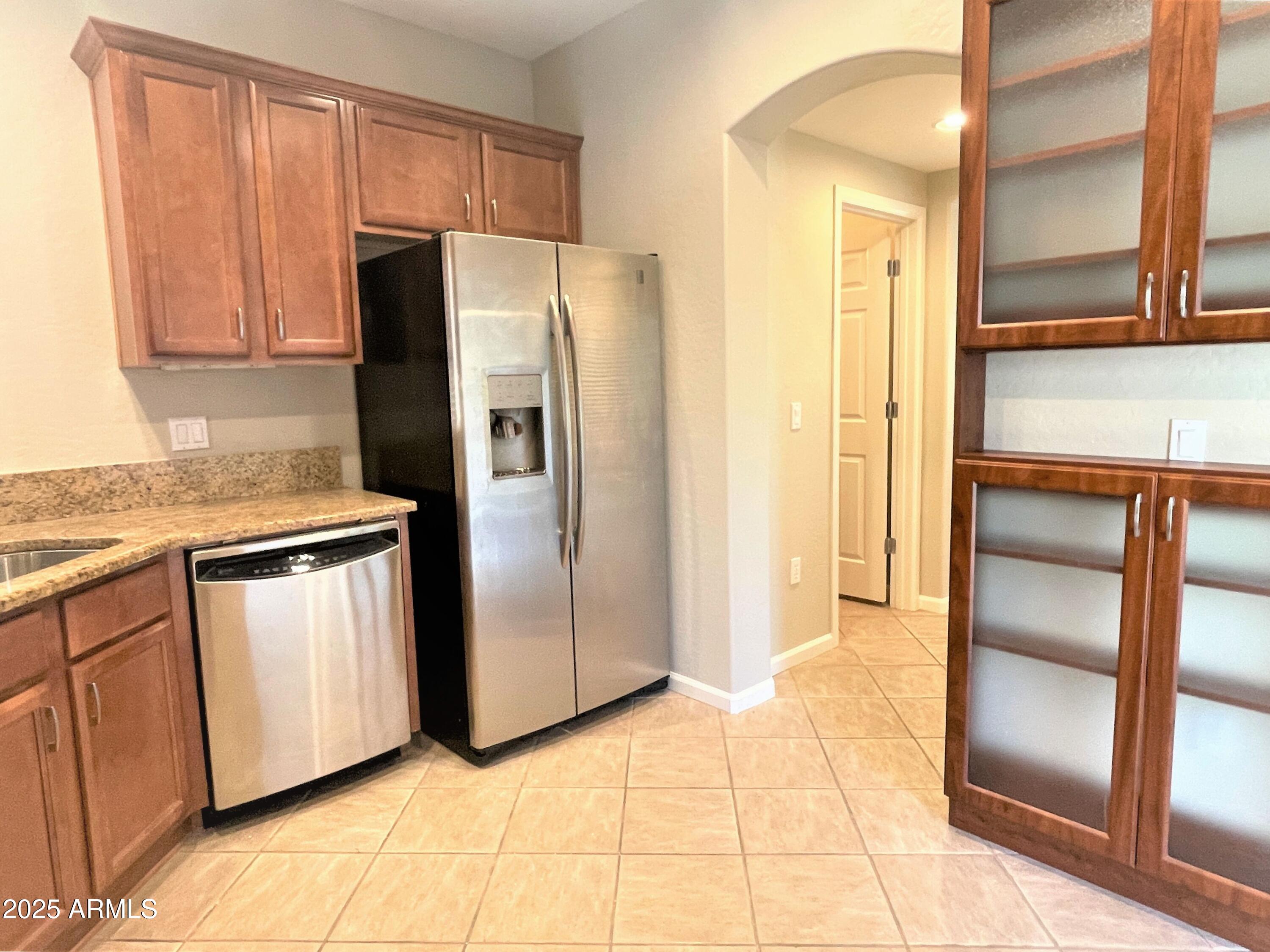 3935 East Rough Rider Road, Unit 1167 Phoenix, AZ 85050 - Photo 10 of 29 a kitchen with stainless steel appliances granite countertop a refrigerator and a stove