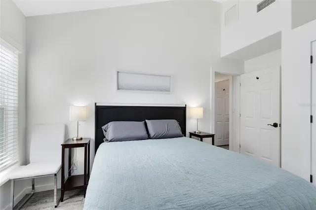 a bedroom with a bed and chair