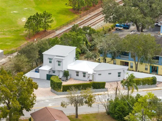 a view of a patio with table and chairs and potted plants