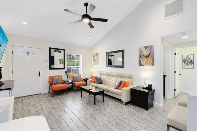a living room with furniture and wooden floor