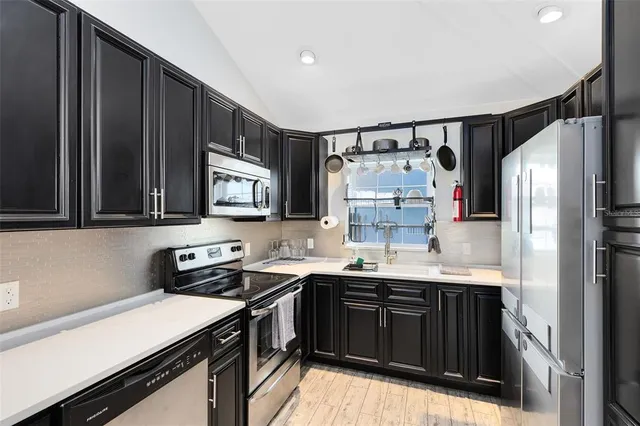 a kitchen with a sink stove and refrigerator
