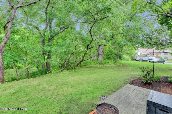 a view of backyard with seating area and green space