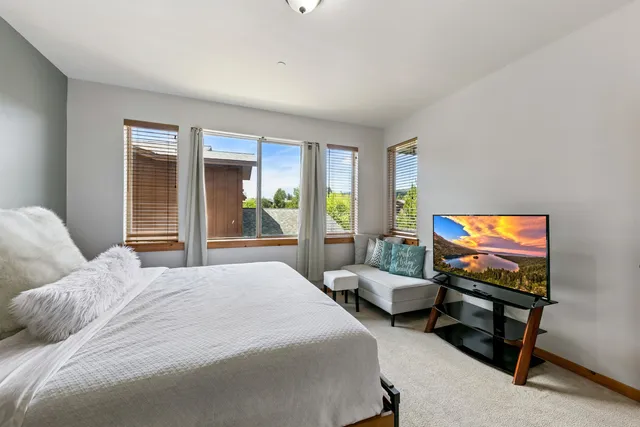 a bedroom with two beds and a flat screen tv