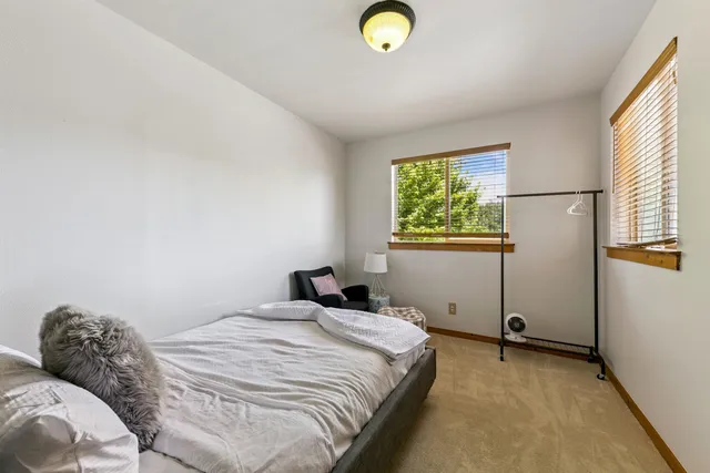 a bedroom with a bed and window