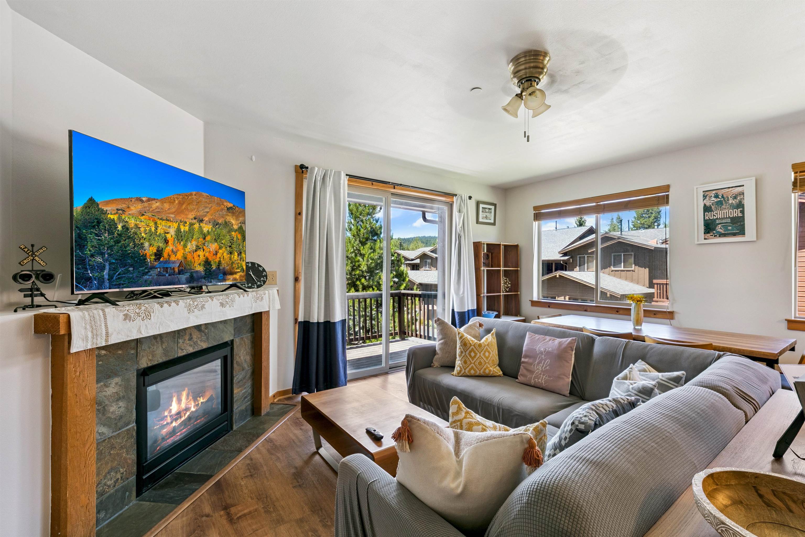 10592 Boulders Road, Unit 8 Truckee, CA 96161 - Photo 4 of 27 a living room with furniture a flat screen tv and a fireplace