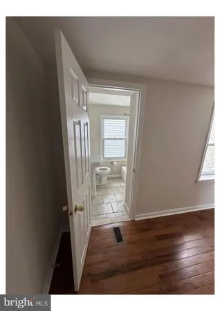 a bathroom with a sink mirror and a bathtub