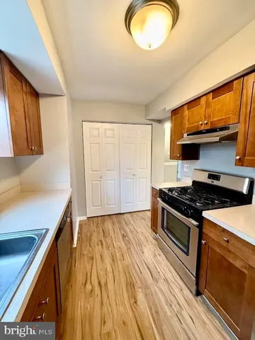 a kitchen with wooden floors and a stove