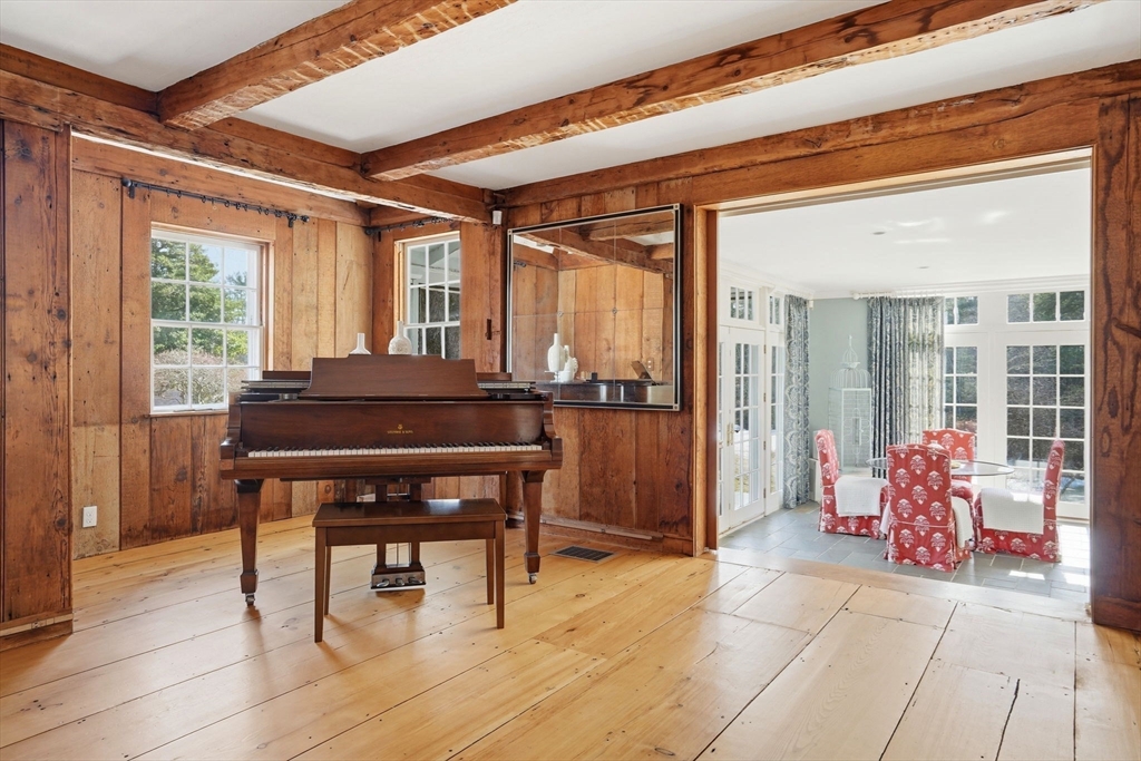 65 Partridge Road Duxbury, MA 02332 - Photo 11 of 42 a living room with a table and chair with wooden floor