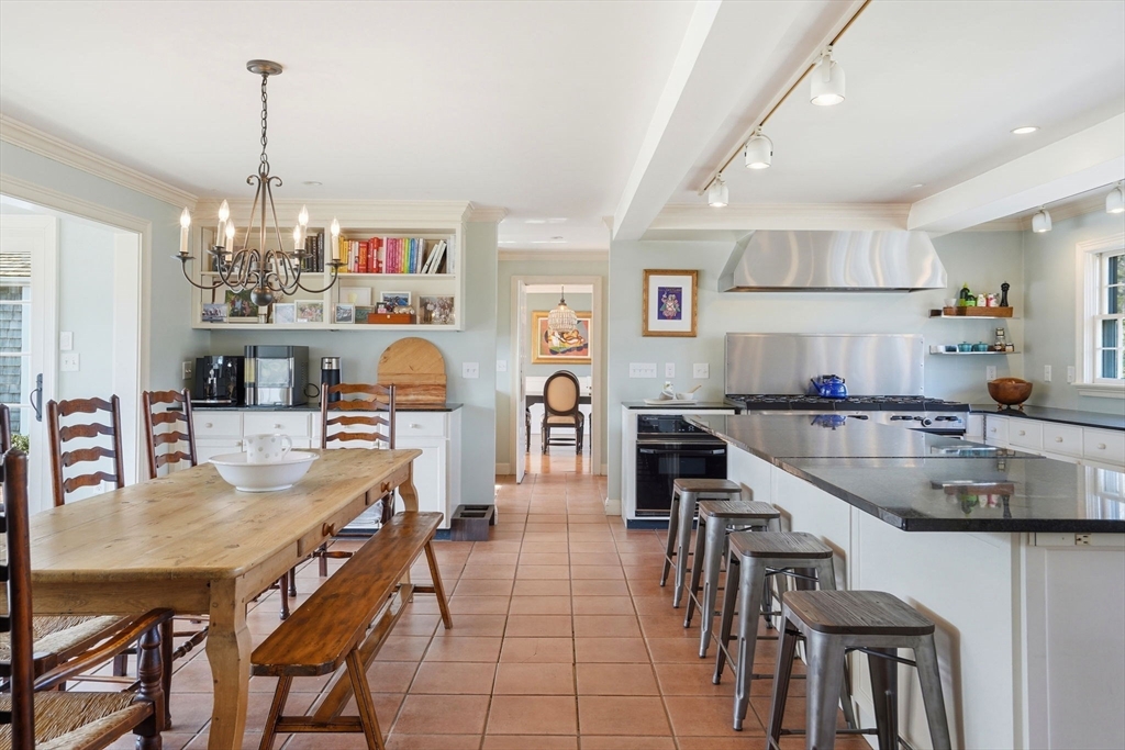 65 Partridge Road Duxbury, MA 02332 - Photo 21 of 42 a kitchen with stainless steel appliances granite countertop a dining table chairs and stove