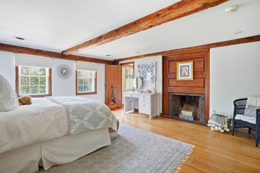 65 Partridge Road Duxbury, MA 02332 - Photo 35 of 42 a spacious bedroom with a large bed and a fireplace