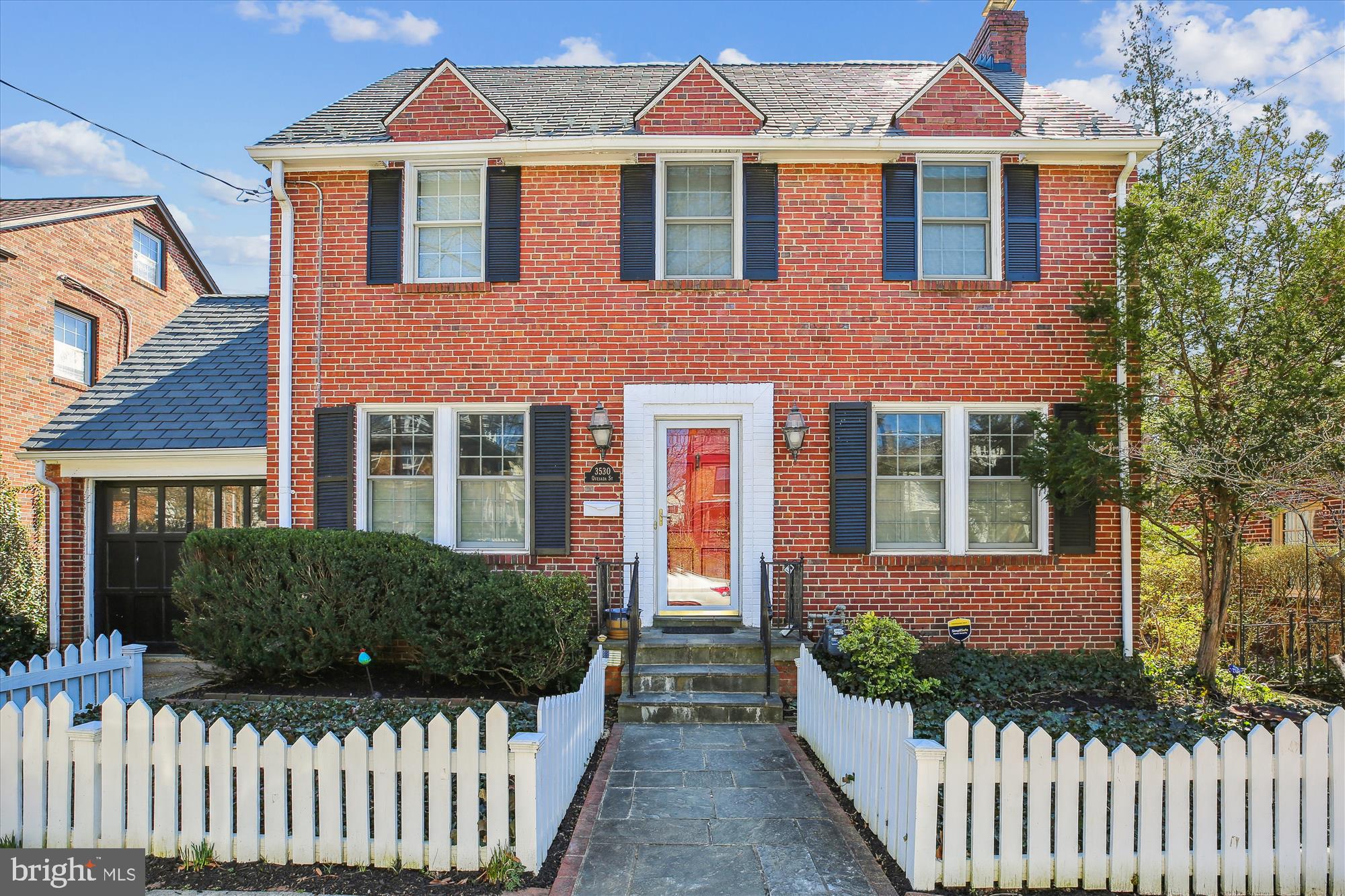 a front view of a house with a garden