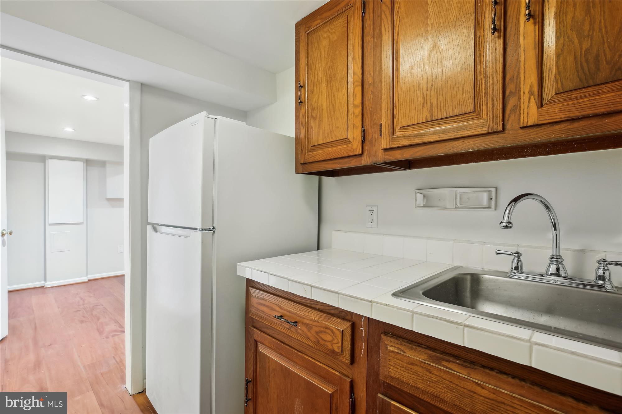 3530 Quesada Street Northwest Washington, DC 20015 - Photo 39 of 54 a kitchen with stainless steel appliances granite countertop a sink and cabinets