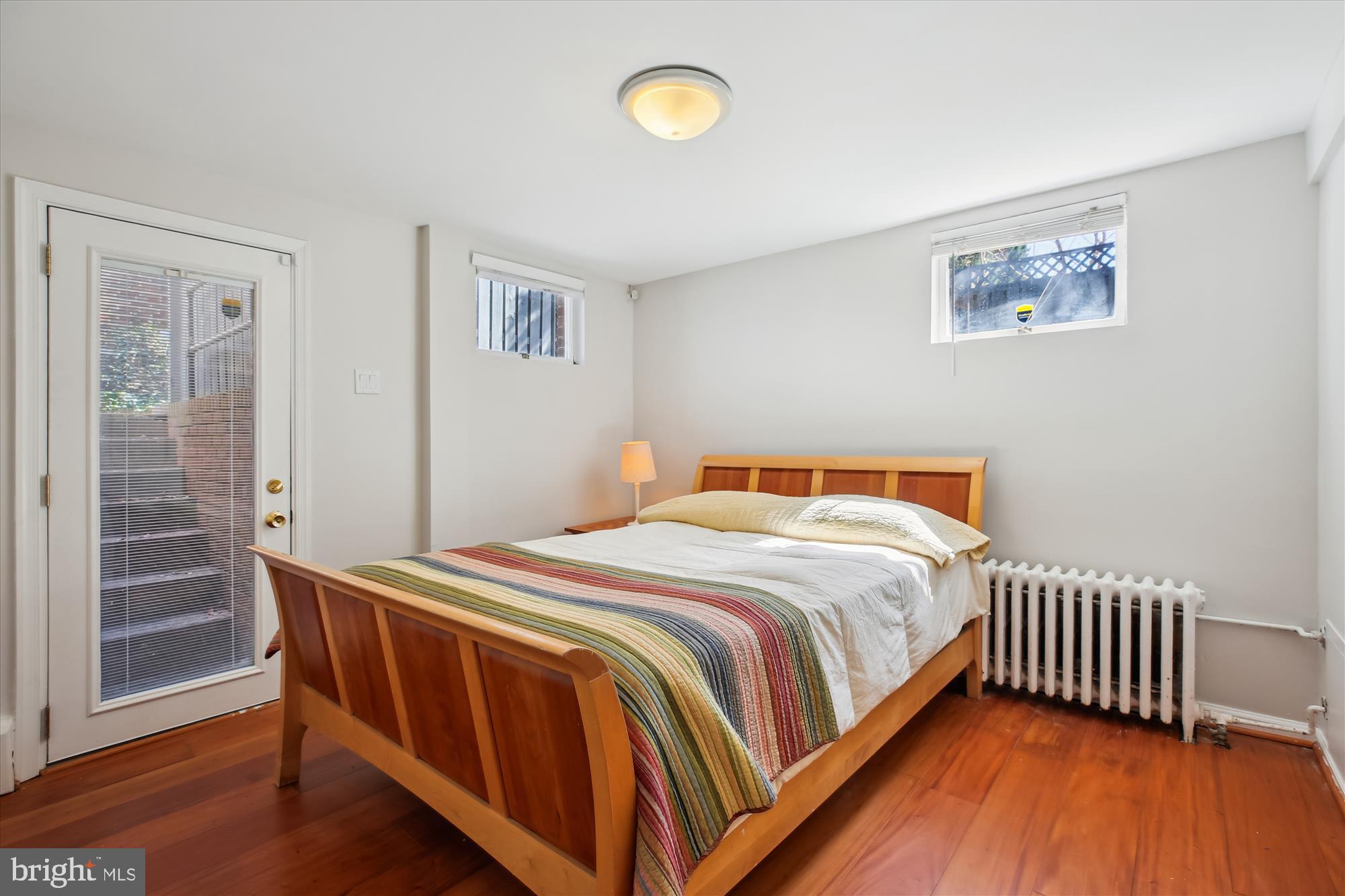 3530 Quesada Street Northwest Washington, DC 20015 - Photo 40 of 54 a bedroom with a bed and wooden floor