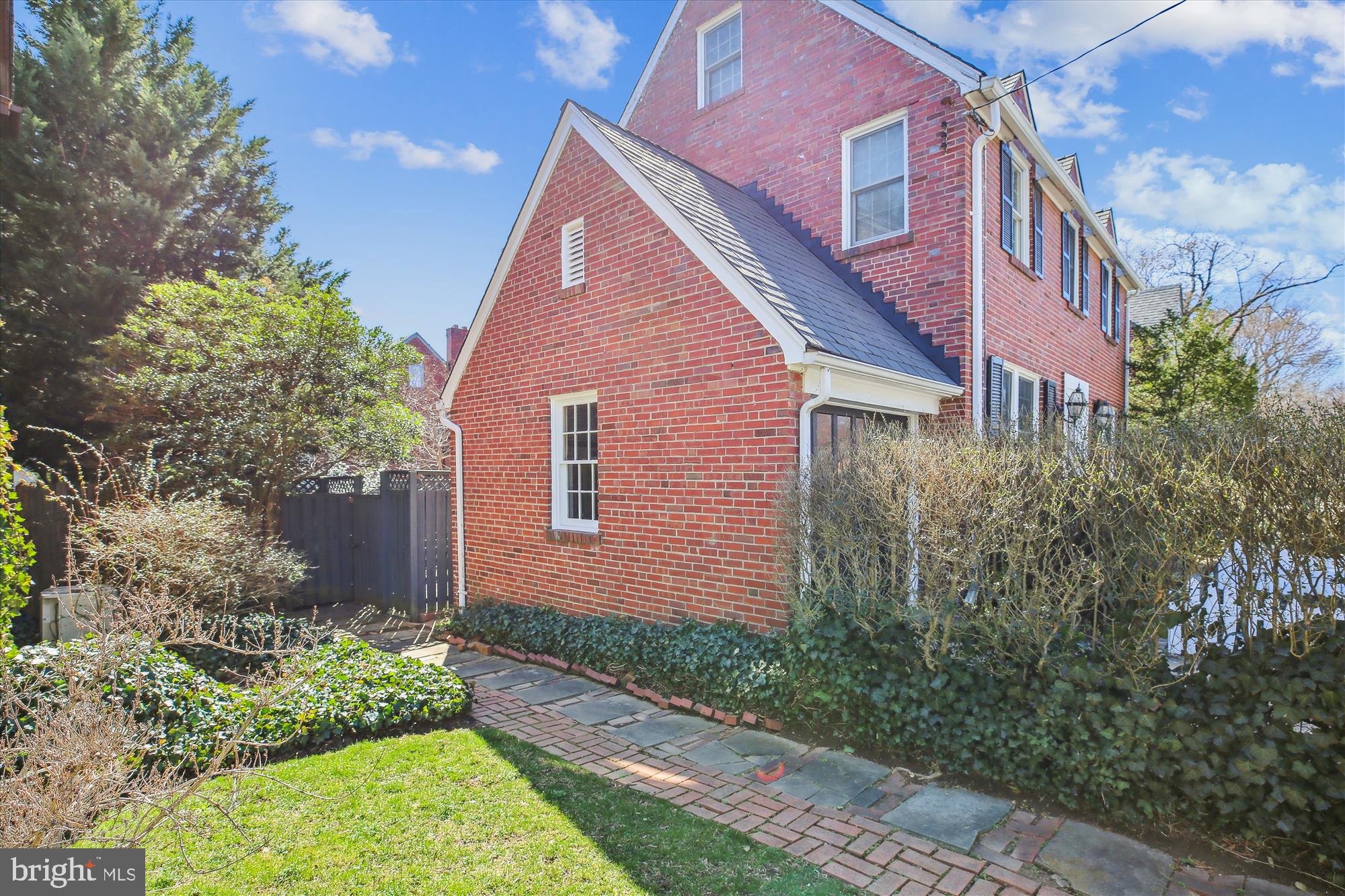 3530 Quesada Street Northwest Washington, DC 20015 - Photo 49 of 54 a view of a brick house with a yard