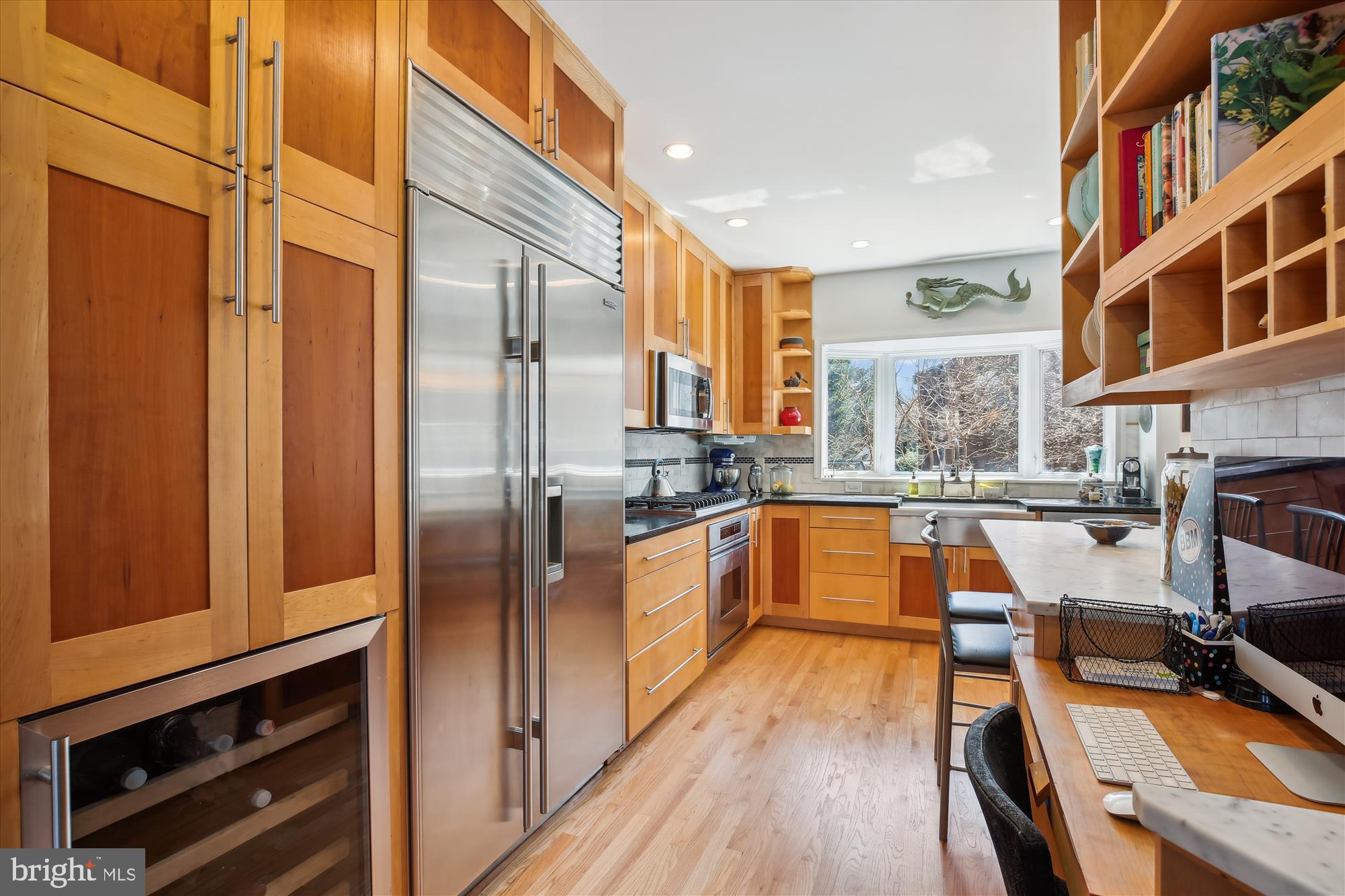 3530 Quesada Street Northwest Washington, DC 20015 - Photo 8 of 54 a kitchen with stainless steel appliances granite countertop a refrigerator a sink dishwasher a stove and white countertops with wooden floor