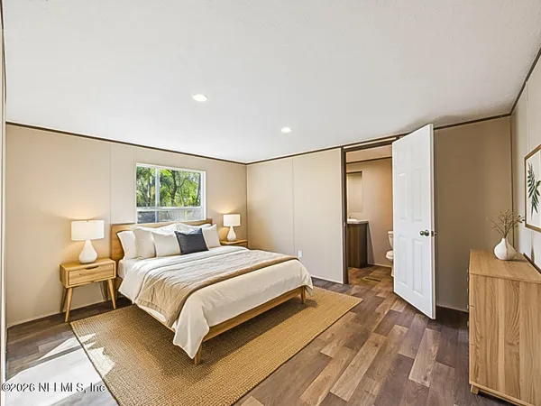 a bedroom with a large bed and a window