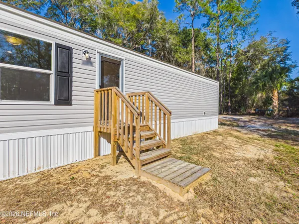 a view of backyard with a deck