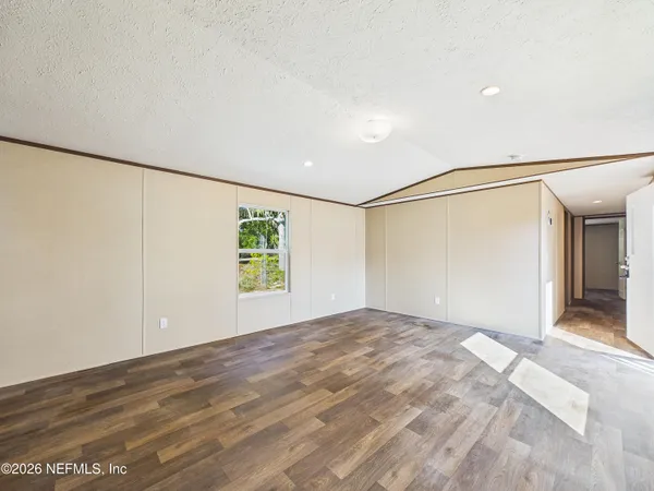 a view of an empty room with a window