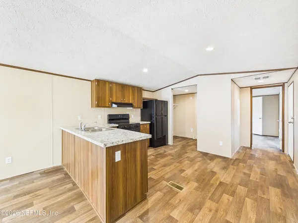 a kitchen with a stove a refrigerator and a sink