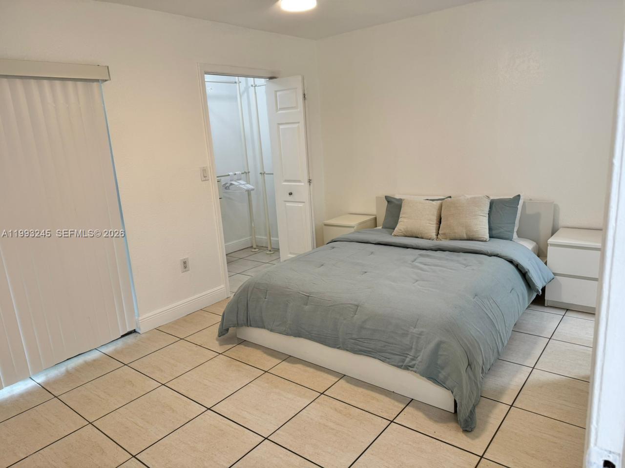 1910 Southwest 17th Avenue, Unit 4 Miami, FL 33145 - Photo 12 of 19 a bedroom with a bed and a shower