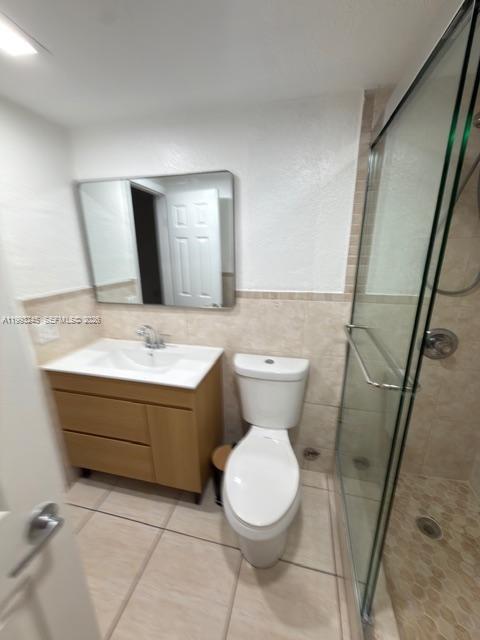 1910 Southwest 17th Avenue, Unit 4 Miami, FL 33145 - Photo 13 of 19 a bathroom with a sink mirror vanity and toilet