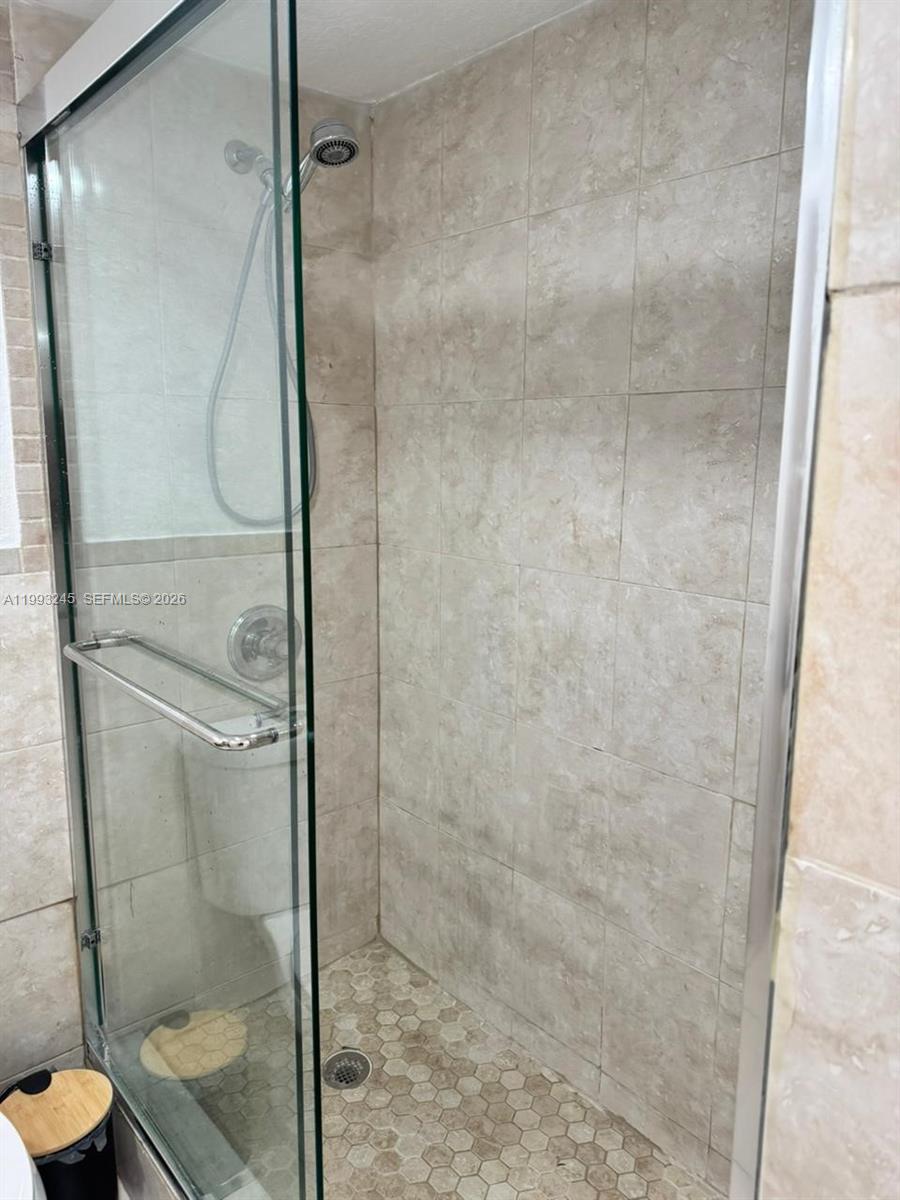 1910 Southwest 17th Avenue, Unit 4 Miami, FL 33145 - Photo 14 of 19 a bathroom with a glass shower door