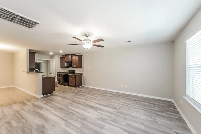 a view of a kitchen with a sink wooden floor and kitchen
