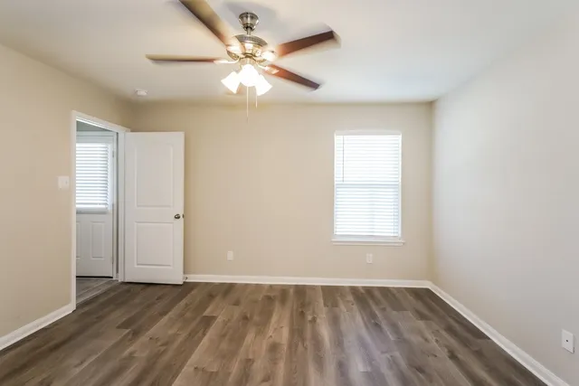 wooden floor in an empty room with a window